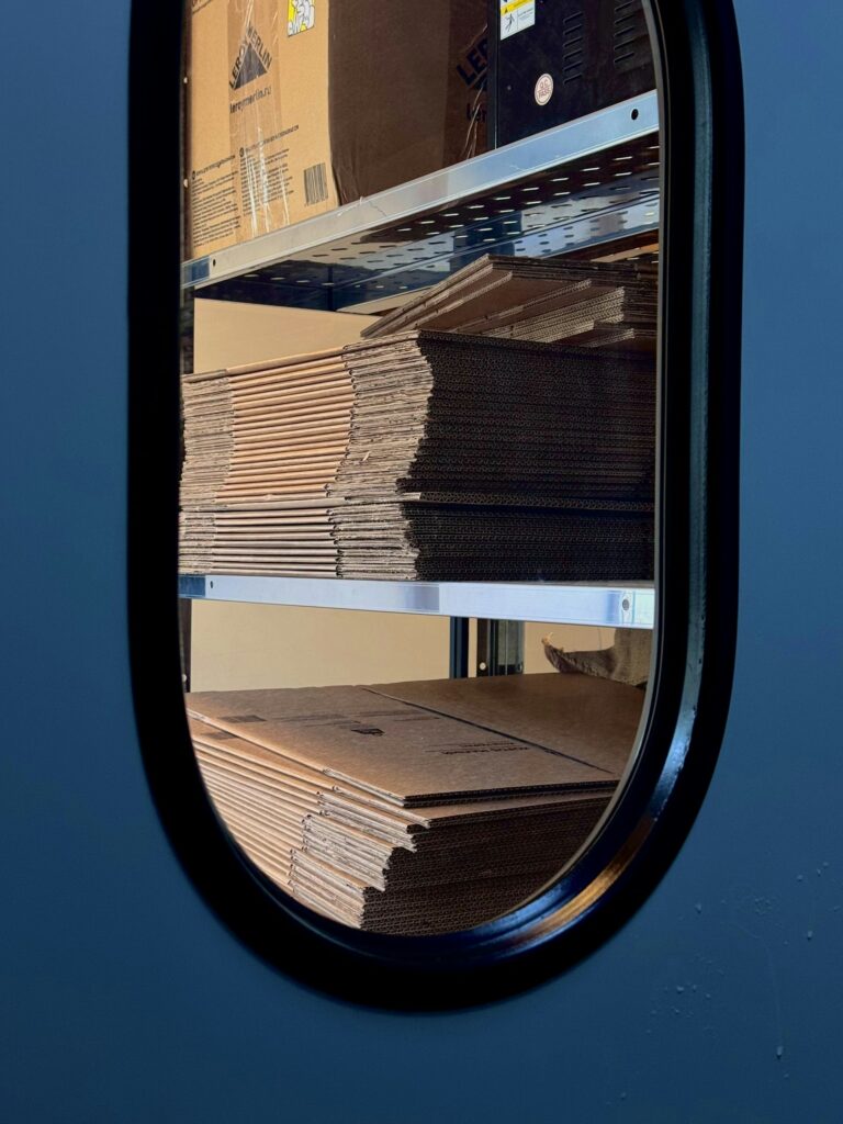 Stacked cartons of purchased wholesale inventory on a storage shelf