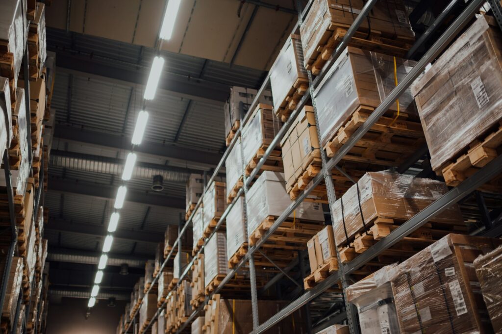 Cardboard cartons of wholesale inventory stacked on a metal warehouse rack